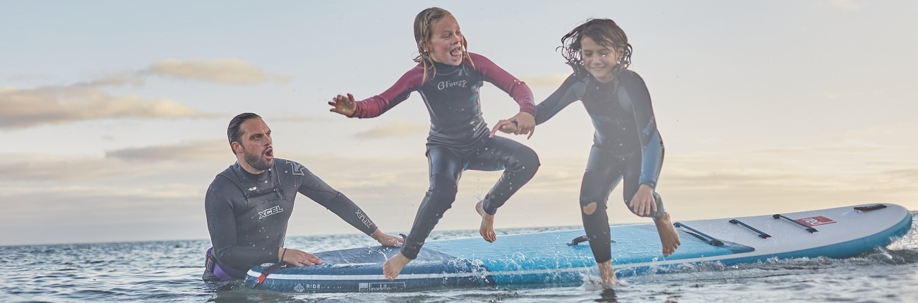 Red Paddle Co SUP kids teens lifestyle group jumping Stand Up Surf Shop 1300x430