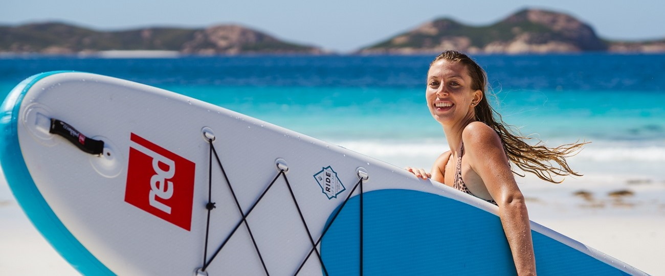 Red-Paddle-Inflatable-SUP-woman-beach-lifestyle-Stand-Up-Surf-Shop 1300x540