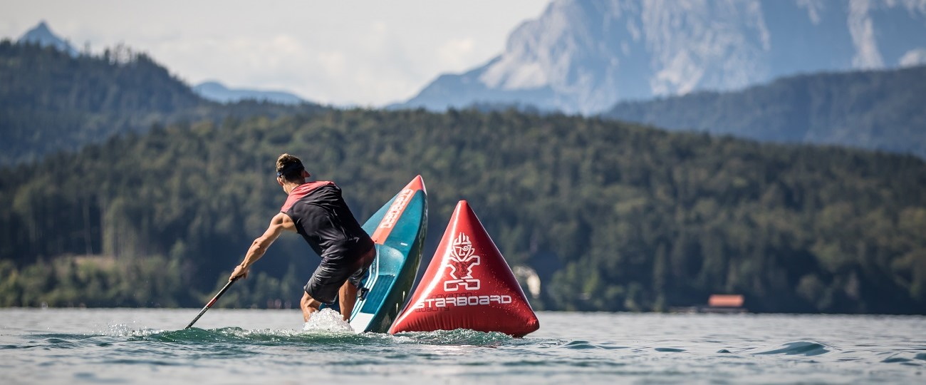 starboard man turning race SUP stand up surf shop 1300x540